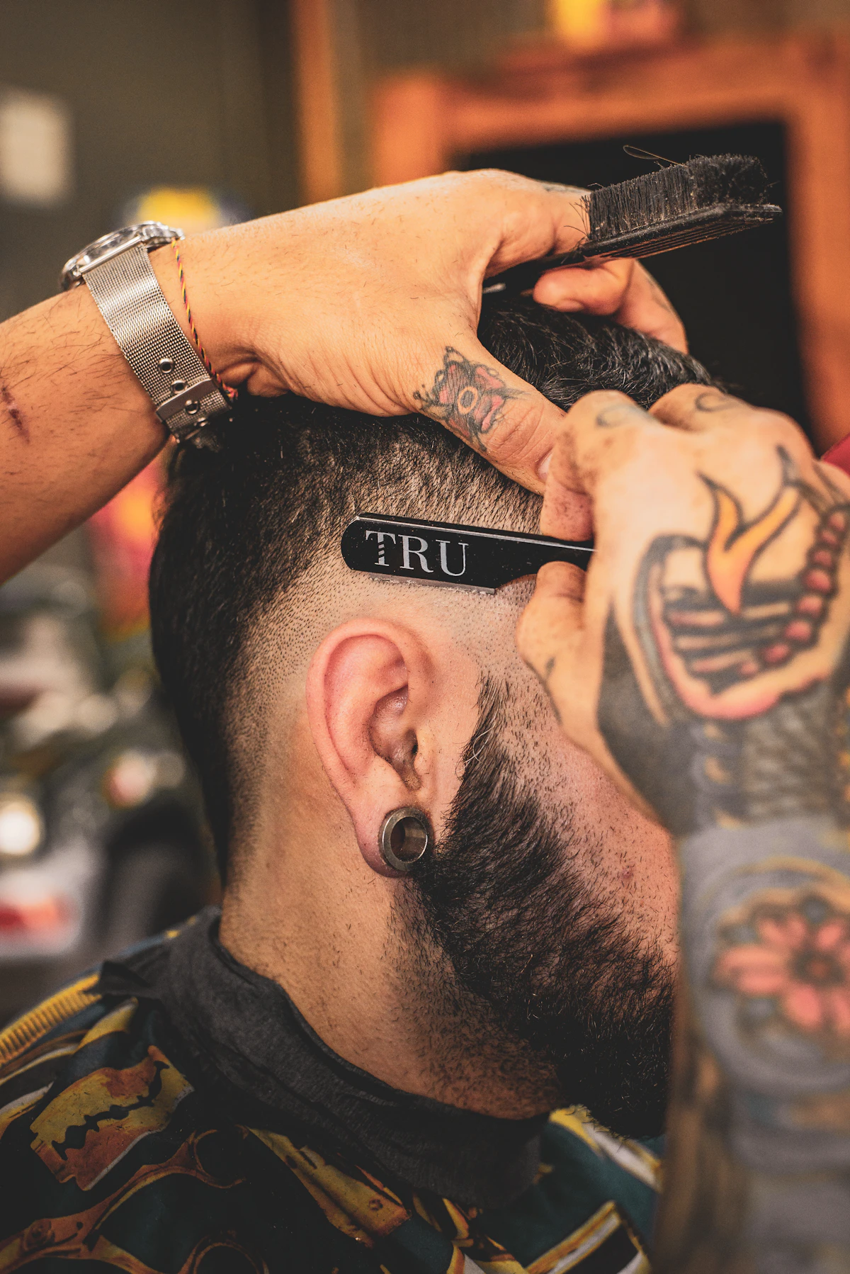 Close detail of barber’s hands and shears during a cut